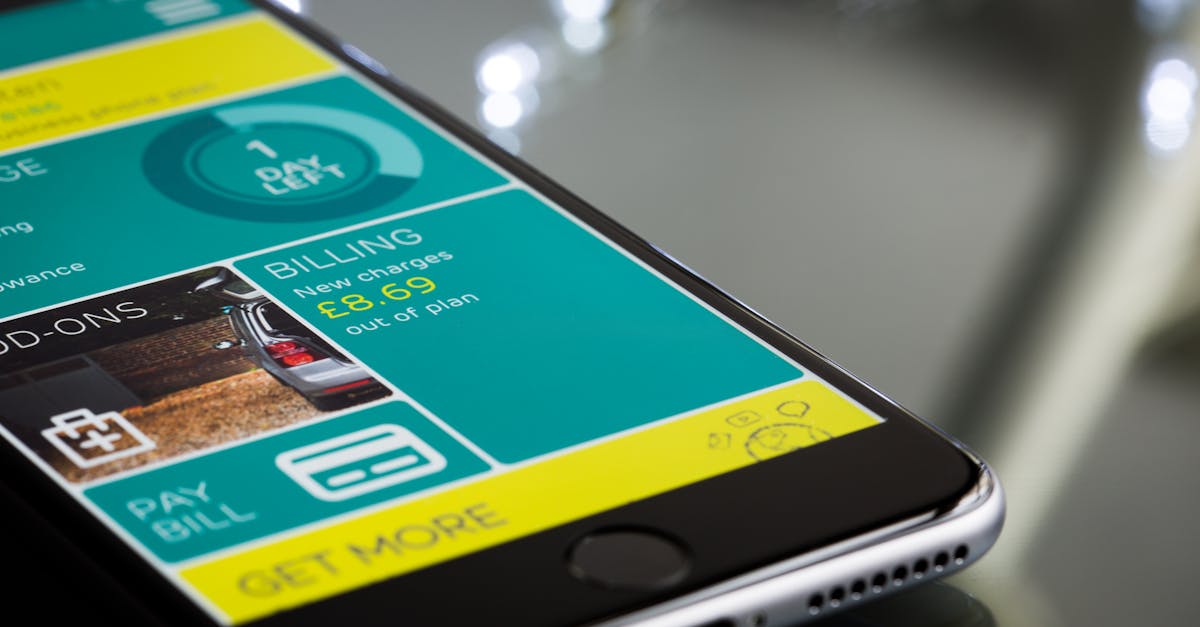 Close-up of a smartphone displaying a billing app interface on a reflective surface.